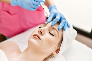 Obraz na płótnie Canvas Doctor injecting botox on woman face for anti aging treatment at the clinic.