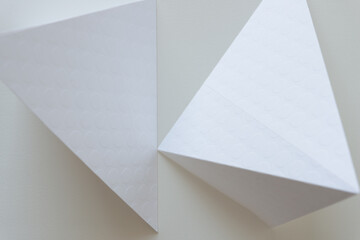 two paper shapes on a white background