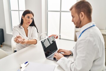 Man and woman doctor and patient having medical consultation at clinic