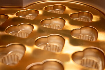 gold foil valentines day heart candy packaging baking container cooking tray empty display background