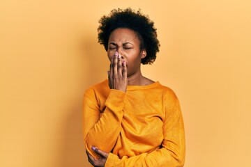 Fototapeta na wymiar Young african american woman wearing casual clothes bored yawning tired covering mouth with hand. restless and sleepiness.