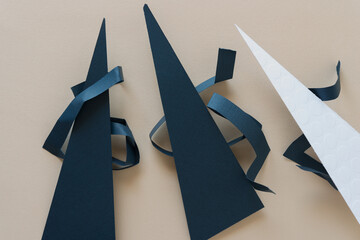 triangular and curled paper shapes on beige