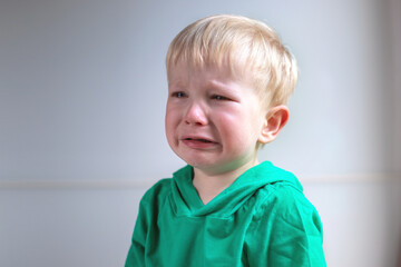 portrait of a crying child on a light background. close-up.