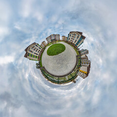 tiny planet in blue sky with clouds in modern multi-storey multi-apartment residential complex of...