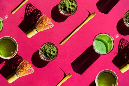 Background of matcha drink and powder with chasen and chashaku