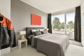 Modern stylish bedroom furnished and decorated in gray colors