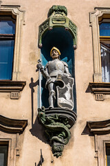 Obraz premium Torun, Poland - August 11, 2021. Building with knight statue sw. Jerzego - in street Most Paulinski 12