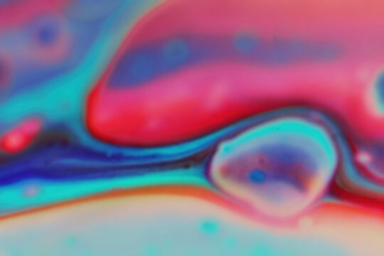 Blurred defocused background with oil paint, red hues, blues and pastels colors, copy space