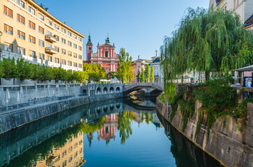 Franciscan Church of the Annunciation and Triple Bridge reflected in Ljublanica river, Ljubljana,...