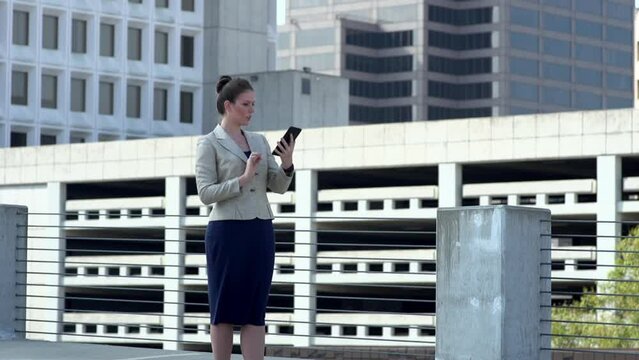 Ecstatic Businesswoman reacting to news on tablet