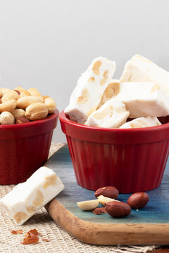 Bars of nougat in red bowl.