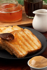Focus on toasted bread with pepper jelly.