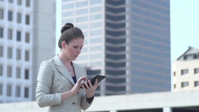 Frustrated Businesswoman working on tablet