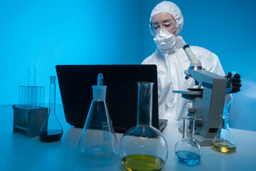 Laboratory technician working. Test tubes and microscope in front of chemist. Laboratory technician...