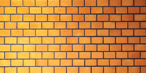 オレンジ色のグラデーションの煉瓦ブロック背景テクスチャー