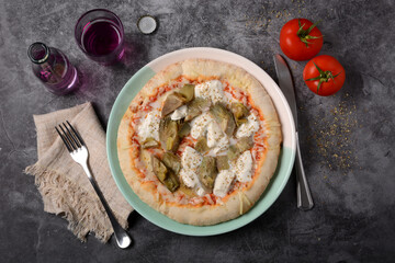 Italian pizza with mozzarella, tomato and artichokes on gray background