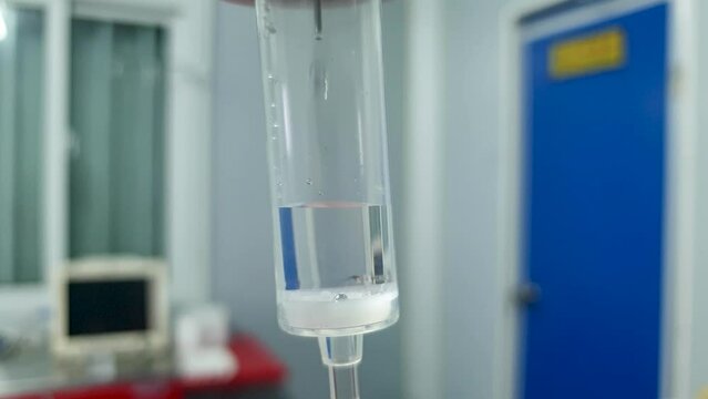 IV intravenous drip fluid hydration medical setup in a hospital clinic, close up of drip with fluid measurements