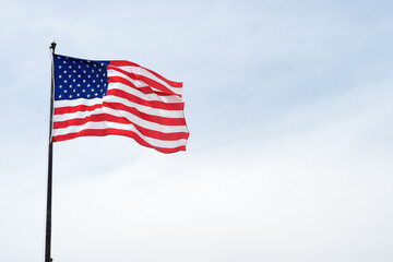 Obraz premium USA flag on blue sky. The star-spangled American flag.