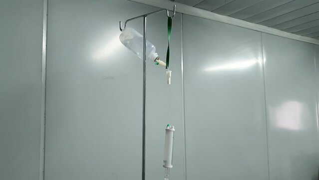 Hydration IV intravenous fluid drip with NaCI sodium chloride setup in a sterile hospital clinic for the next patient