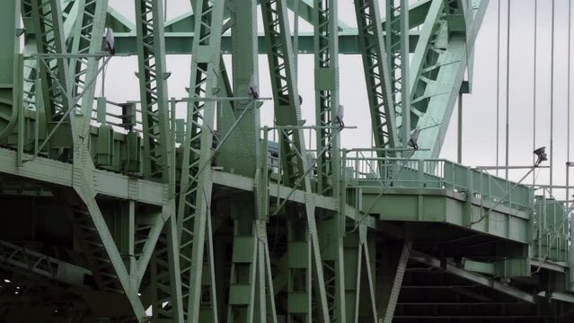Close up green iron girders Runcorn silver Jubilee bridge traffic crossing