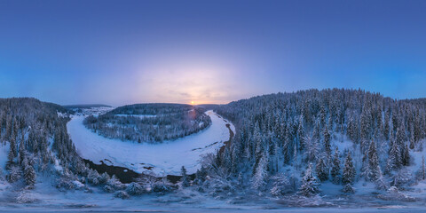 360 degree panorama of a winter river from above and a snow-covered forest