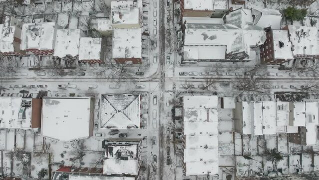 backwards tracking overhead view of snowy Clinton St. in Carroll Gardens Bkln