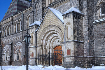 Front of old stone gothic style college building at the University of Toronto in winter