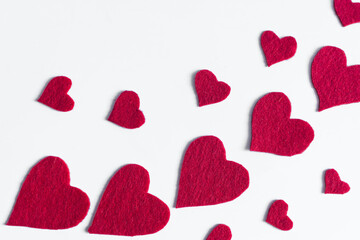 Large and small red hearts on a light background top view.