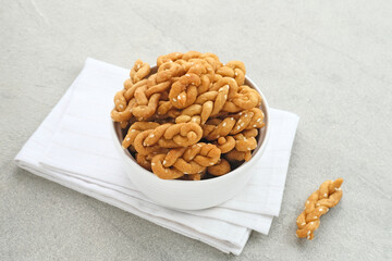 Kue Tambang or Untir untir is a traditional Indonesian cookies made from wheat flour, sugar, eggs and sesame seeds. Selected focus.
