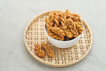 Kue Tambang or Untir untir is a traditional Indonesian cookies made from wheat flour, sugar, eggs and sesame seeds. Selected focus.
