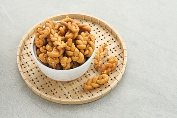 Kue Tambang or Untir untir is a traditional Indonesian cookies made from wheat flour, sugar, eggs and sesame seeds. Selected focus.
