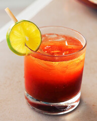 cocktail drink on a table with lemon slice in a glass