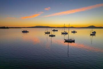 Aerial sunrise waterscape with boats
