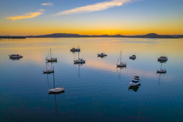 Fototapeta premium Aerial sunrise waterscape with boats