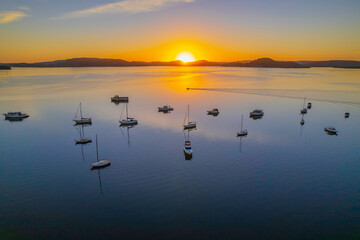 Obraz na płótnie Canvas Aerial sunrise waterscape with boats