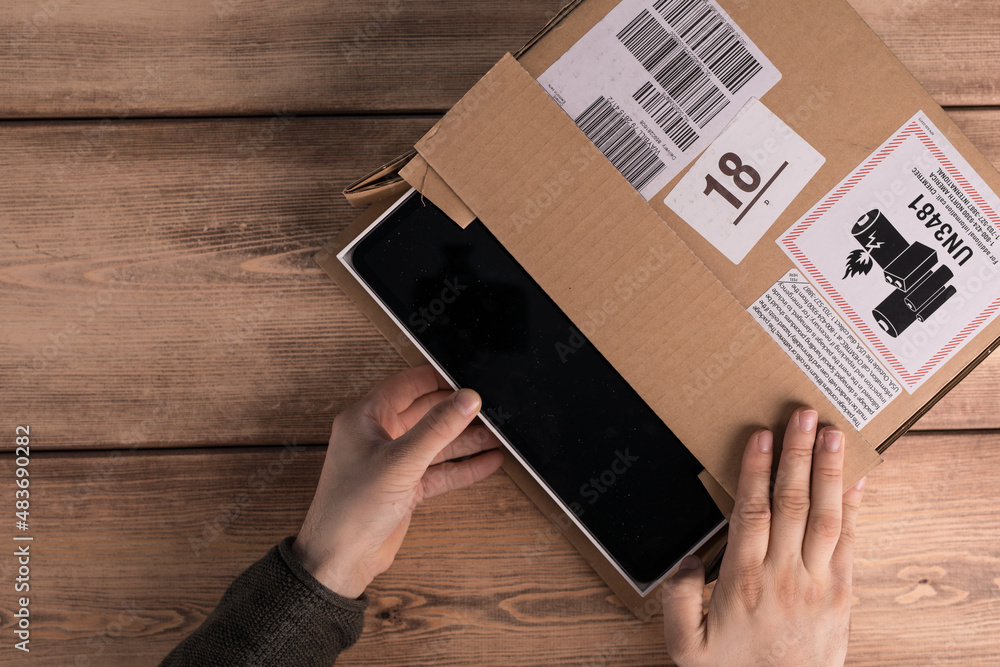 Canvas Prints A closeup of a man opening a cardboard box