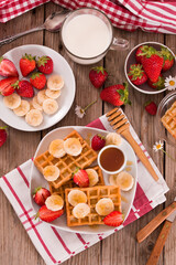 Waffles with strawberries, bananas and honey.