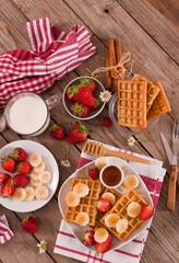 Waffles with strawberries, bananas and honey.