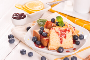 Lemon pund cake with blueberries and strawberry syrup.