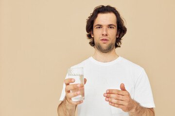 Cheerful man glass of water in his hands emotions posing isolated background