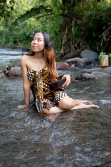 Portrait of young girl in river, woman posing on the water 