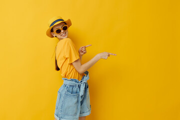 young woman in a yellow hat Youth style casual wear in sunglasses isolated background