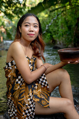 Portrait of young girl in river, woman posing on the water 