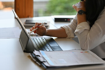 Close up with Businesswoman using digital tablet for analyze business date, Business and financial...