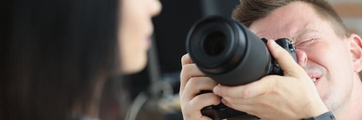 Man photographer is taking pictures of woman closeup