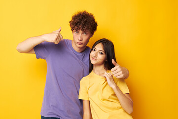 cute young couple in colorful t-shirts posing friendship fun isolated background unaltered
