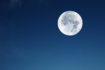 Full Moon on a blue evenign sky.