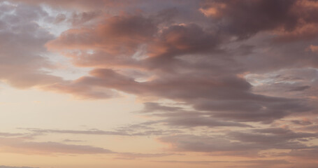 Naklejka na ściany i meble background of clouds on evening sky with bird and landing plane