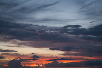 clouds slowly float in the sky during sunset