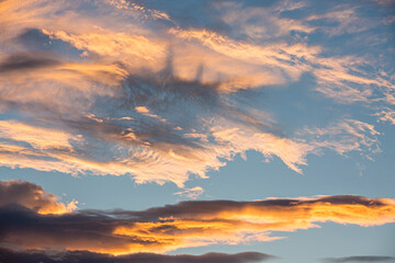 Colorful orange and blue dramatic sky with clouds for abstract background over Graz, Austria.